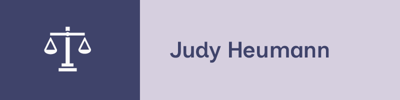 A two-tone graphic with an icon featuring the scales of justice in white against a dark blue background on the left side, and the name "Judy Heumann" in blue against a light purple background on the right side.