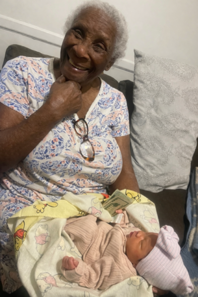 Image of elderly African American woman with baby on her lap